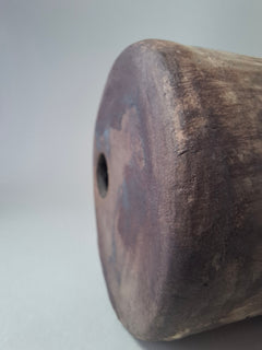 Close-up of the handmade anthracite stoneware surface of Rubble Vase III, showing the burnished mineral texture and small opening.