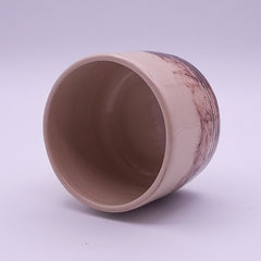 Handmade 200 ml Yunomi cup in natural cream stoneware with a dark iron oxide pattern and carved horizontal lines around the base, shown on a dark background.