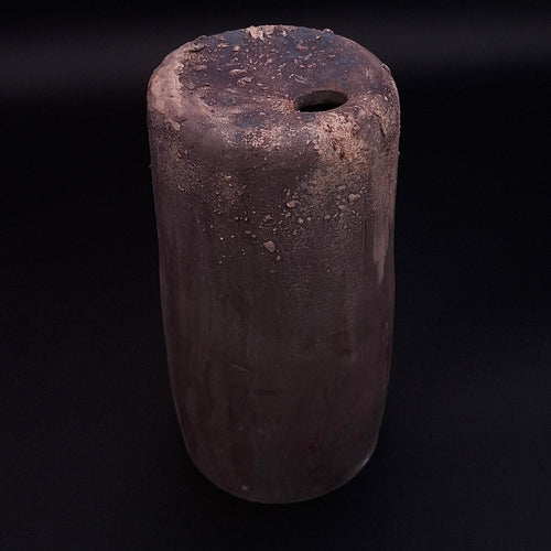 Handmade Rubble Vase II in anthracite stoneware with an iron oxide surface and textured mineral details, shown against a black background.
