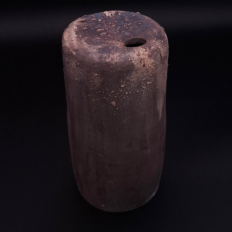 Handmade Rubble Vase II in anthracite stoneware with an iron oxide surface and textured mineral details, shown against a black background.
