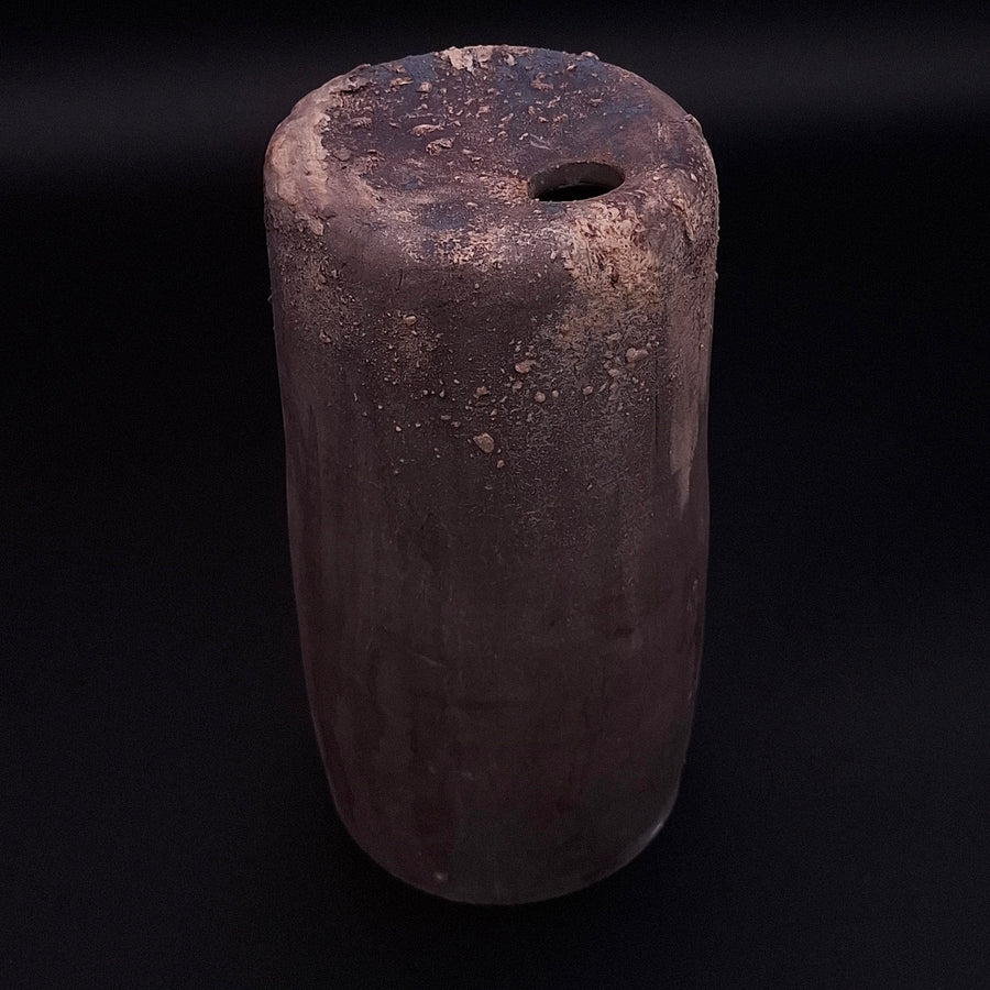 Handmade Rubble Vase II in anthracite stoneware with an iron oxide surface and textured mineral details, shown against a black background.
