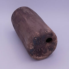 Side view of the handmade Rubble Vase II in anthracite stoneware, showing its rounded cylindrical form, irregular iron oxide surface and small opening.