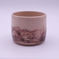 Handmade 200 ml Yunomi cup in natural cream stoneware, showing the irregular dark iron oxide pattern and horizontal carved lines around the base.