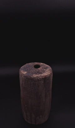Rubble Vase II, a handmade anthracite stoneware vessel with a dark iron oxide surface and textured top, photographed against a black background.